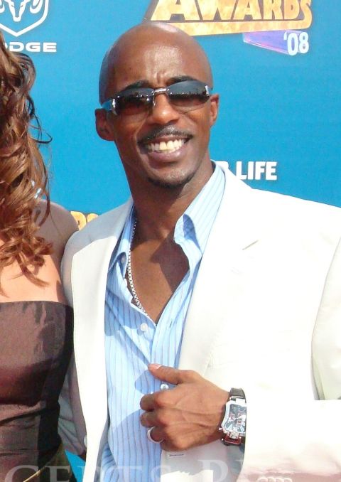 Ralph Tresvant  poses a picture in a white suit.